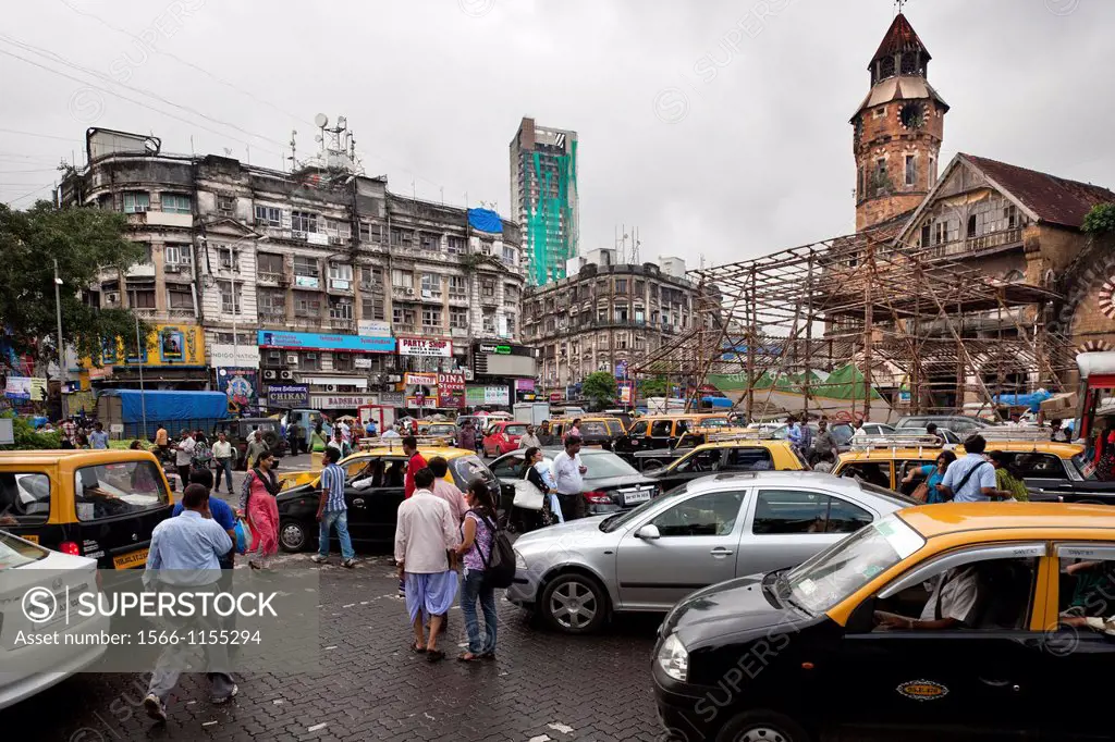Taxis, cars, bikes and pedestrians try driving on the streets of Mumbai