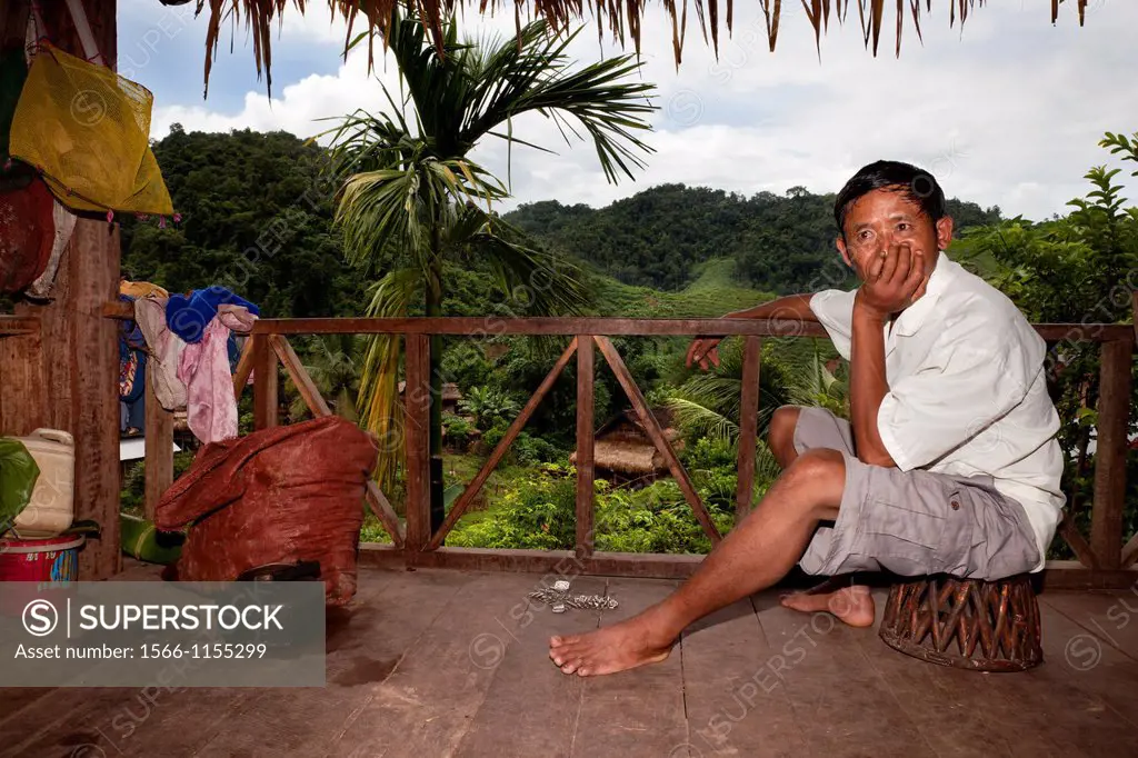 one farmer resting on the balcony of his home after a hard day´s work
