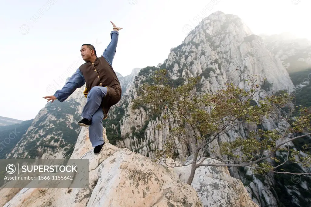 Shaolin Monk Shi De Jian of the San Huang Zhai Monastery demonstates traditional martial arts on the mountainside of Song Mountain