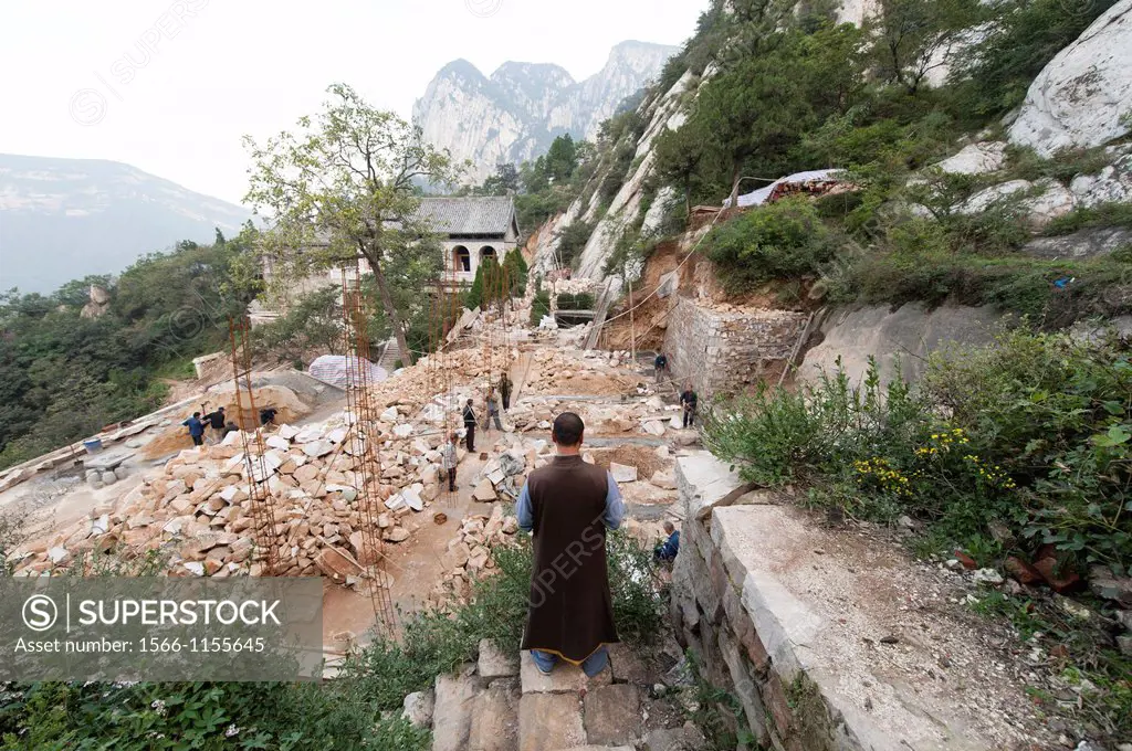 Shaolin Monk Shi De Jian overlooks construction at San Huang Zhai Monastery on Song Mountain, China
