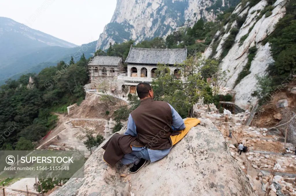 Shaolin Monk Shi De Jian overlooks construction at San Huang Zhai Monastery on Song Mountain, China