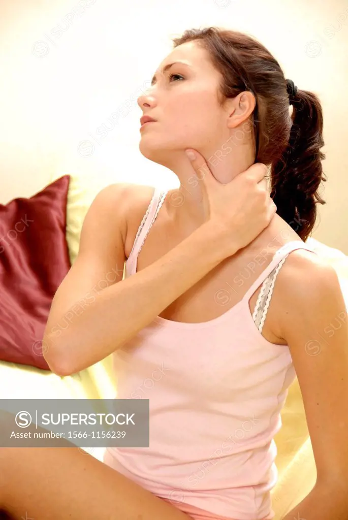 Young woman holding her painful or stiff neck