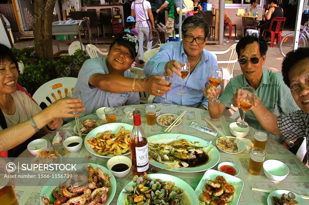 Eating seafood and drinking Tariquet armagnac in a harbour restaurant on the Island of Cheung Chau, Hong Kong, China