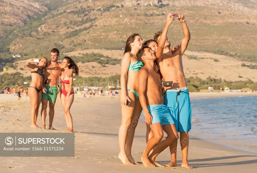 Group of friends at the beach. Punta Paloma, Tarifa, Costa de la Luz, Cadiz, Andalusia, Spain.