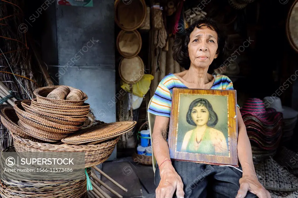 Woman with her own portrait, Philipppines.