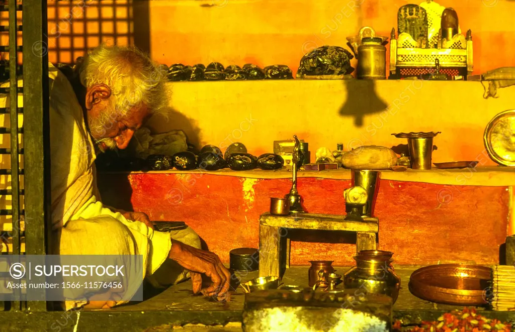 man in little shop at the ghats of varanasi, india