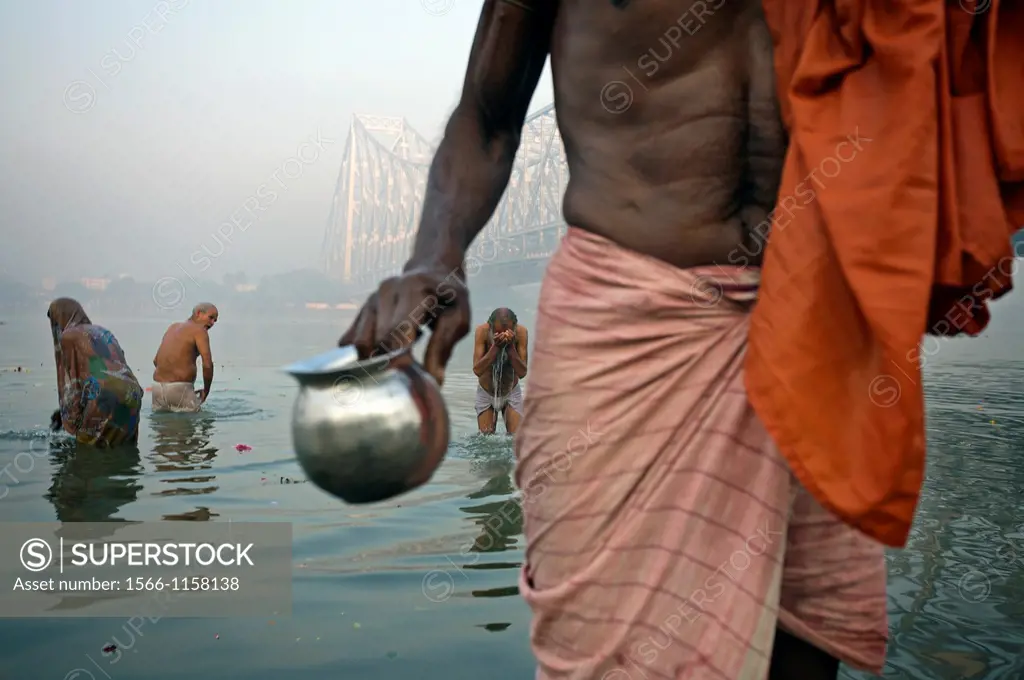 Sadhu by the Howrah Bridge, Hooghly River, Kolkata, India, Ganges River.