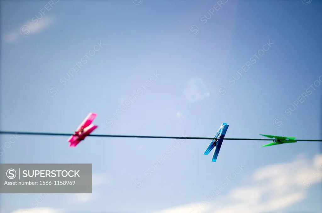 clothesline with three clothes pegs
