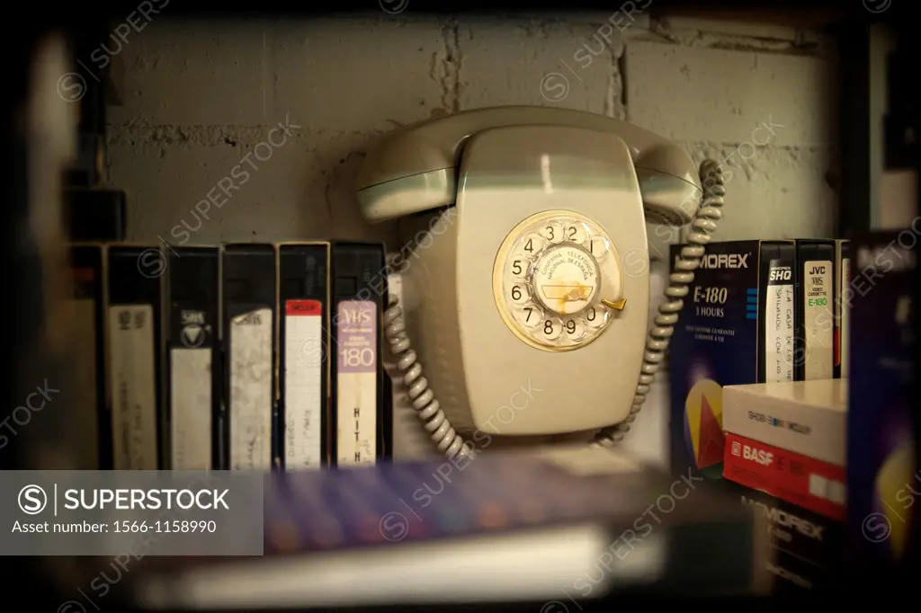 Vintage Telephone group dim with VHS movies.
