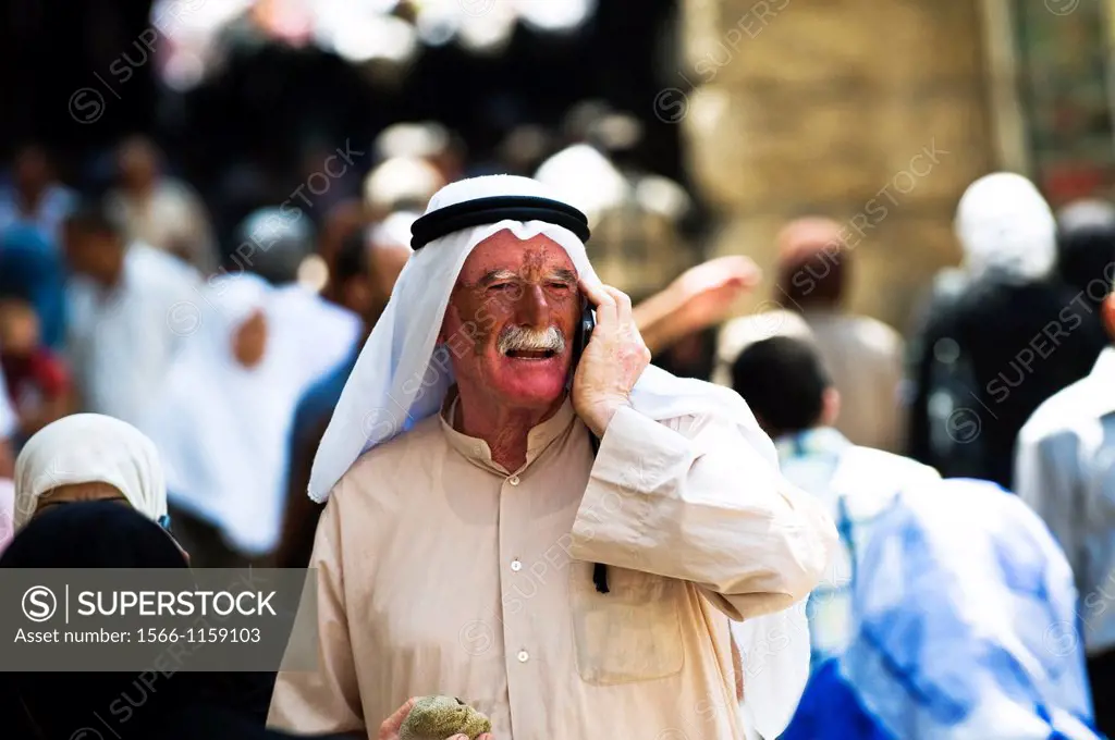 An Arab Palestinian man walking through the narrow streets of the Musim qt  in the old city of Jerusalem