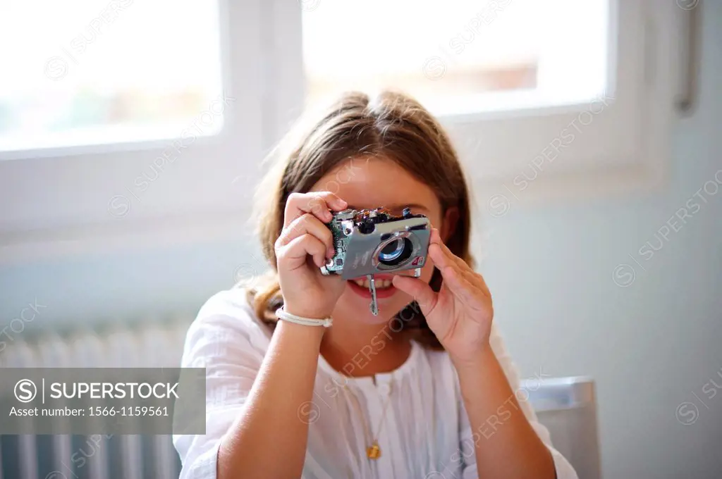 Girl plays with broken camera