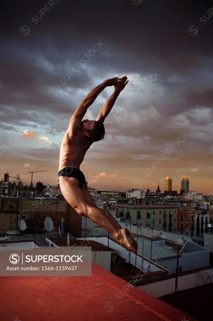 Professional Dancer striking a pose with the city of Barcelona in the background, Spain