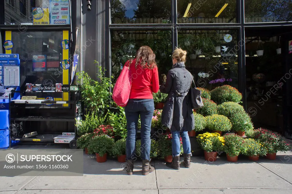Women shop for fall flowers at a florist in the Upper West Side neighborhood of New York