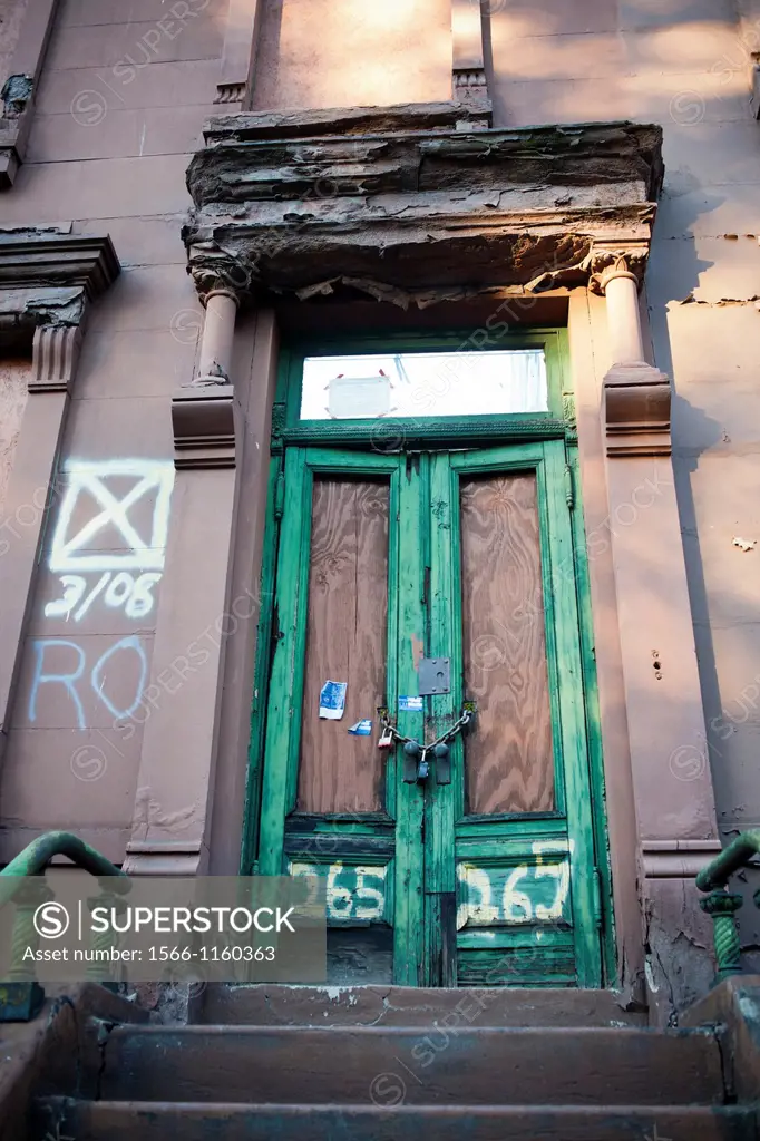 Dilapidated brownstone is for sale and awaiting restoration, in Harlem in New York