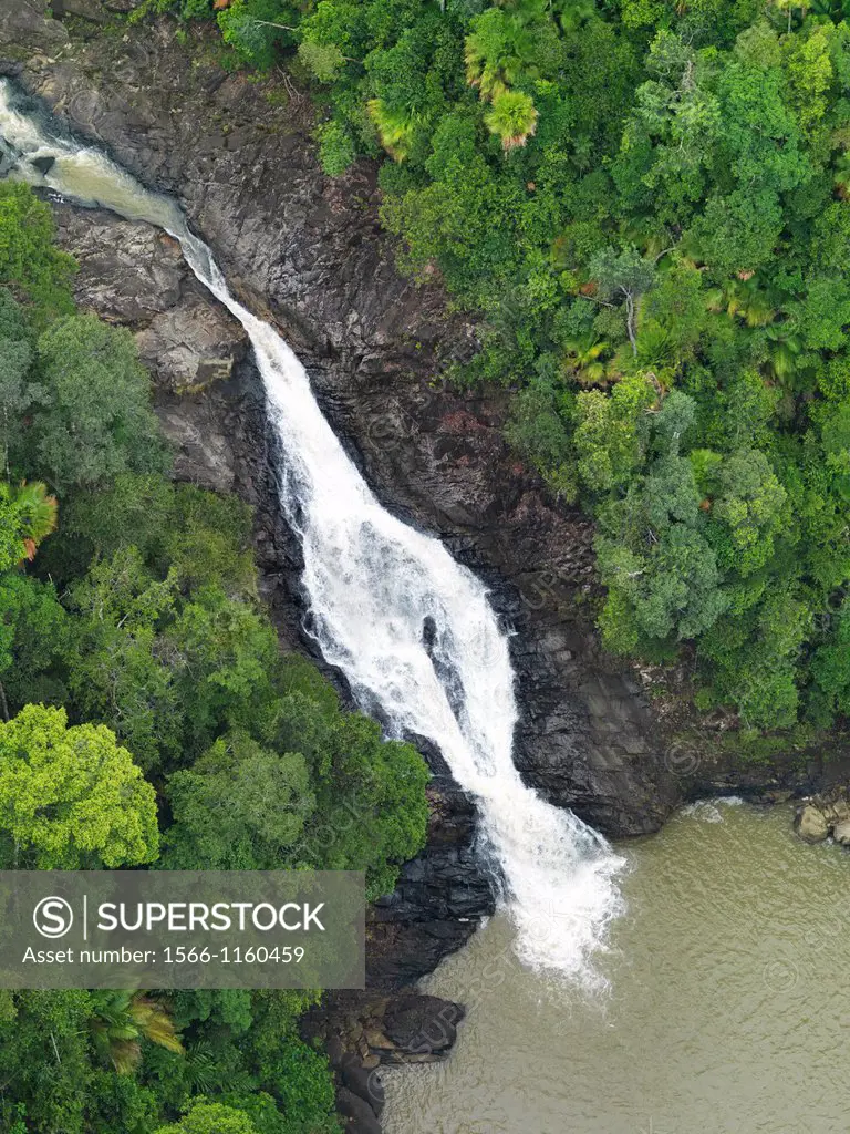 An aerial image of a waterfall cutting through the dense jungle in Johor, Malaysia