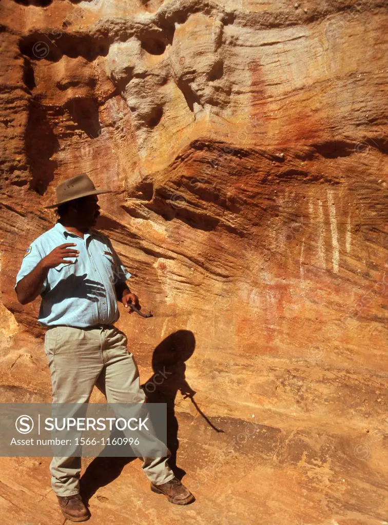 Aboriginal ranger Michael Whyman interprets rock art, Mootwingee National Park, outback New South Wales, Australia