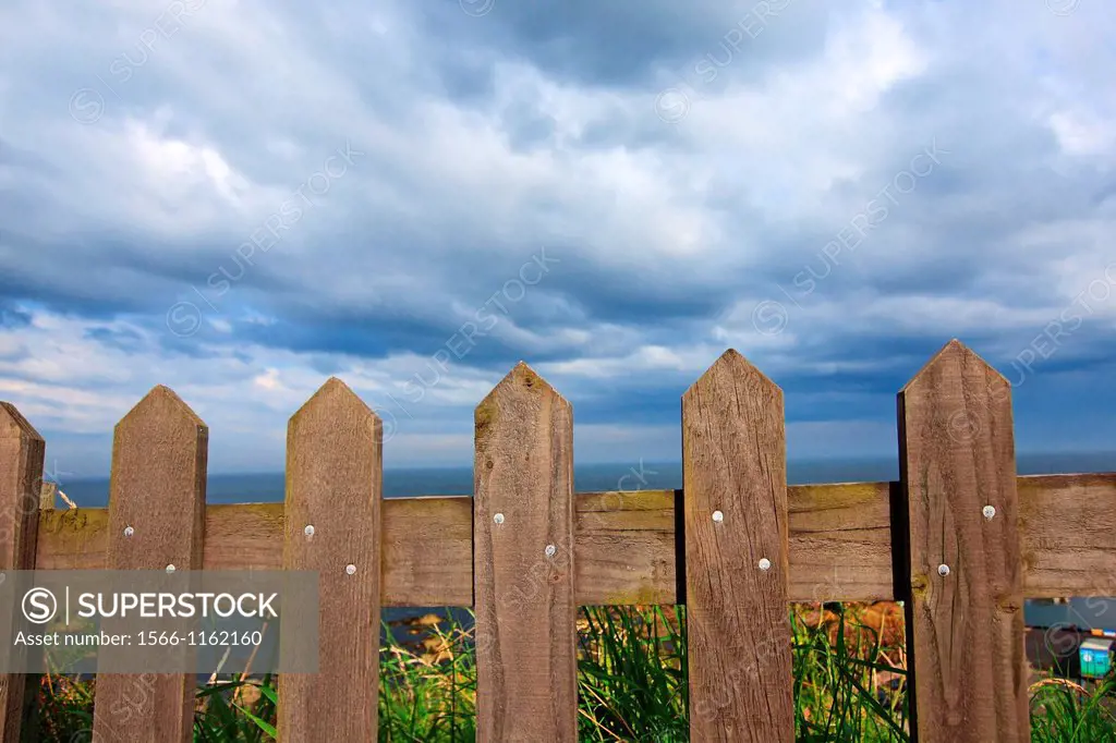 Wodden fence close up against blue sky