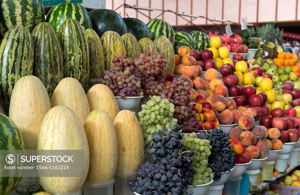 Artistically displayed melones, grapes, peaches and other fruits on the Green market, Almaty, Kazakhstan