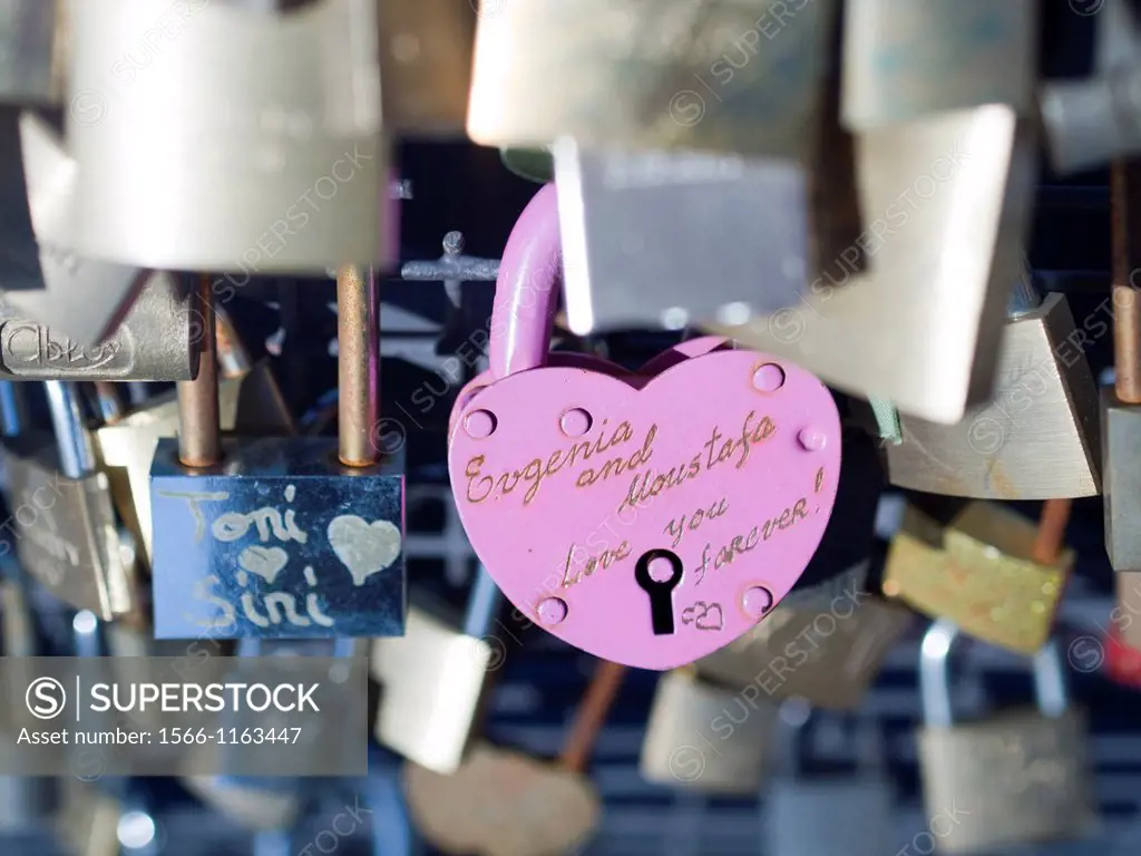 Locks left by romancing couples attached to bridge in accordance with local custom in Helsinki, Finland