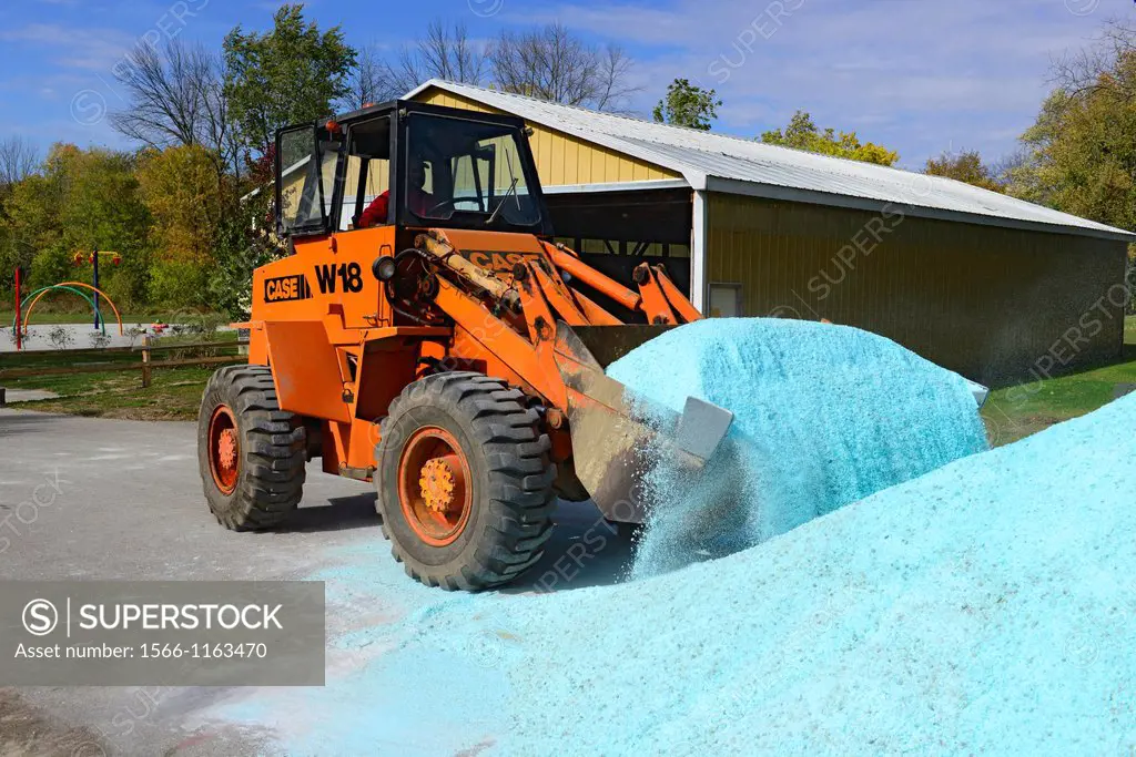 Equipment moving salt stockpile in preparation for winter snowstorms
