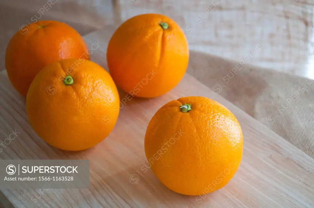 Four oranges. Still life.