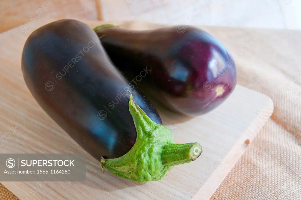Two aubergines on a chopping board. Still life.