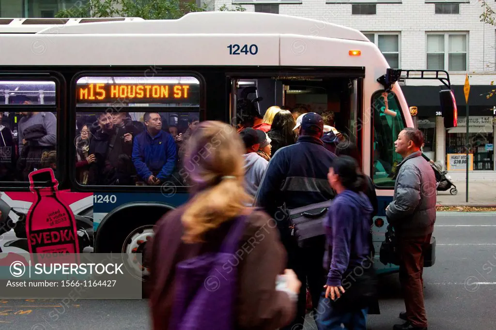 NEW YORK, NY, USA - OCTOBER 31, 2012: Bus Service having resumed after Hurricane Sandy hit the city, MTA busses remain rare and overcrowded in blacked...