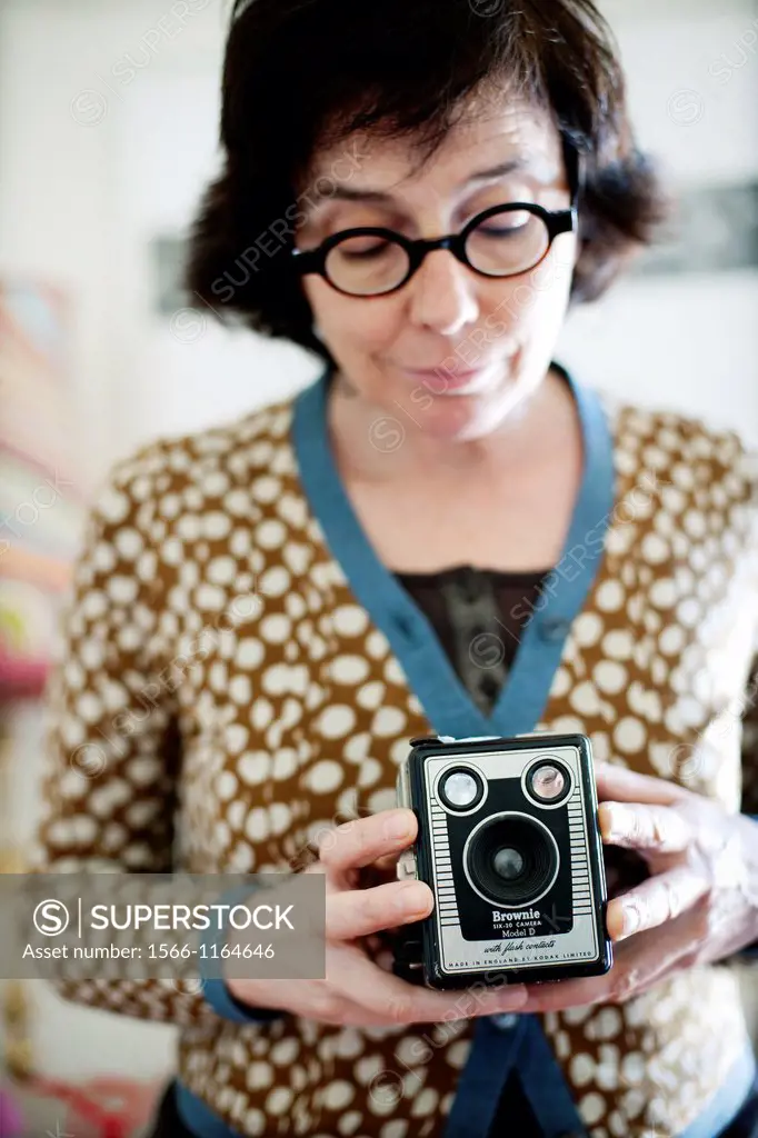 woman taking pictures with old Kodak Brownie camera