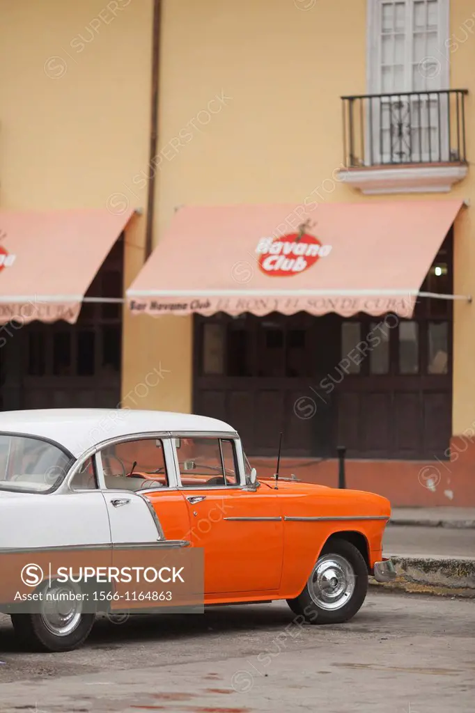 Cuba, Havana, Havana Vieja, morning view of Old Havana street with 1950s-era US car