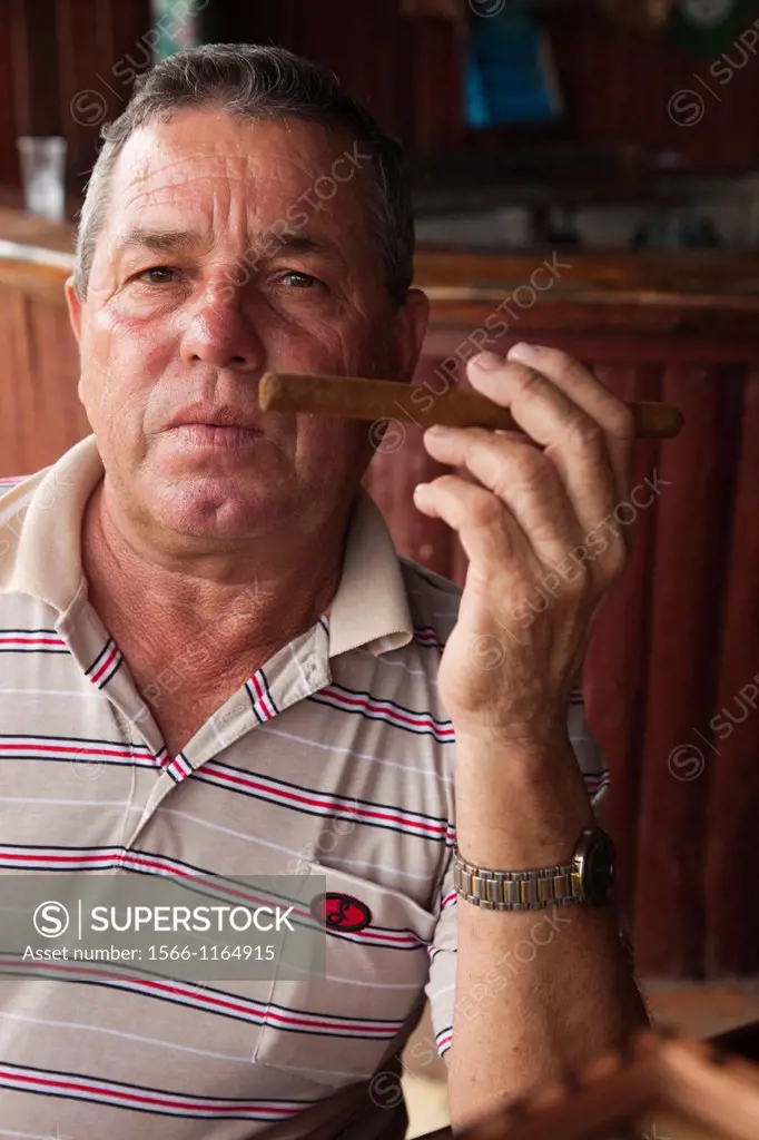 Cuba, Pinar del Rio Province, Vinales, Vinales Valley, tobacco planter smoking Cuban cigar, NR