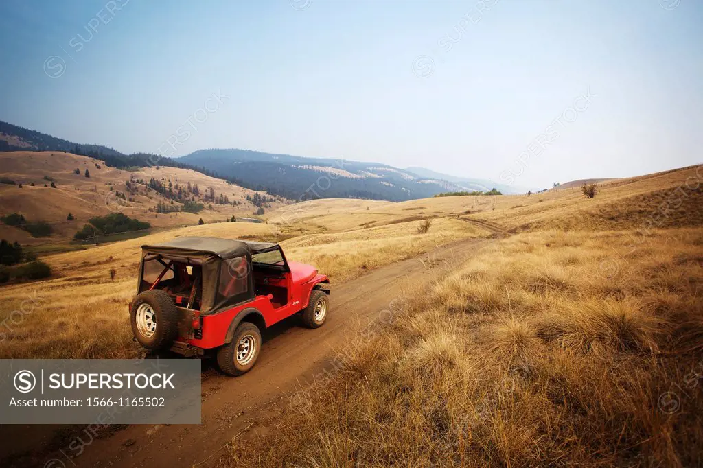 Red jeep going off road in Kamloops, British Columbia, Canada