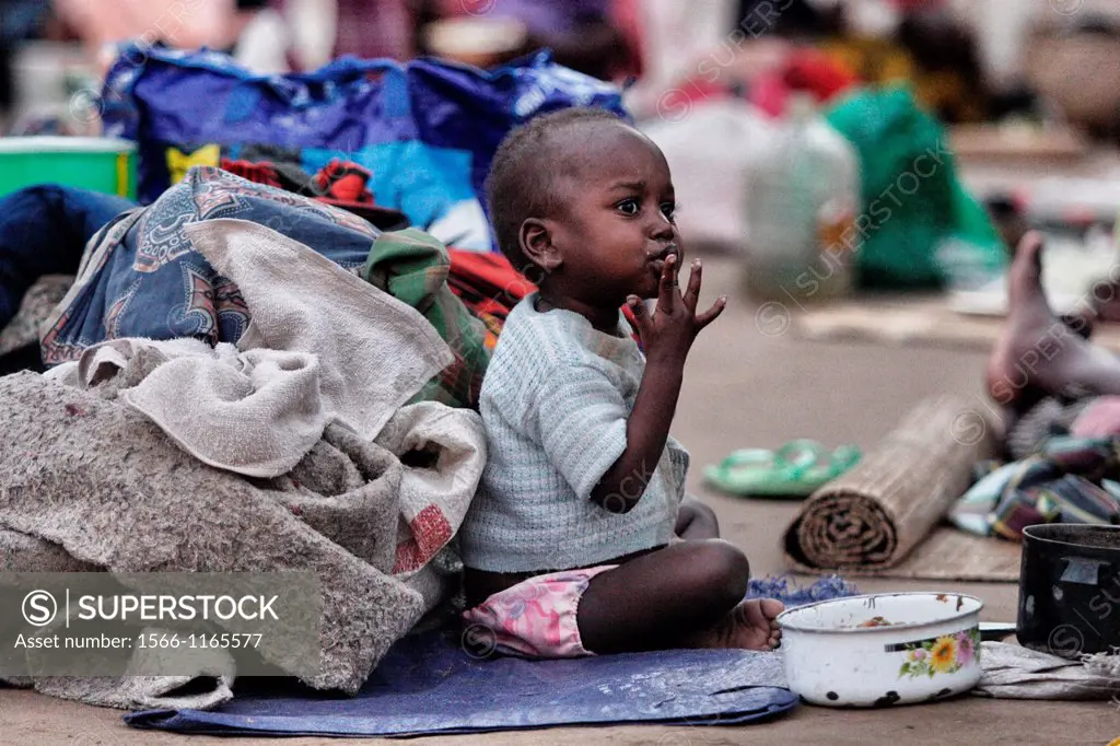 Boy eating outside the Chalucuane Hospital, Mozambique