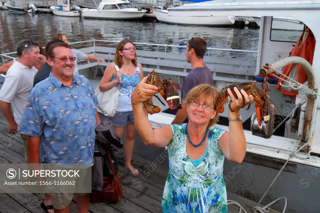 Maine, Portland, Historic Old Port District, Long Wharf, Lucky Catch Cruises, lobstering excursion, man, woman, couple, holding, lobster,