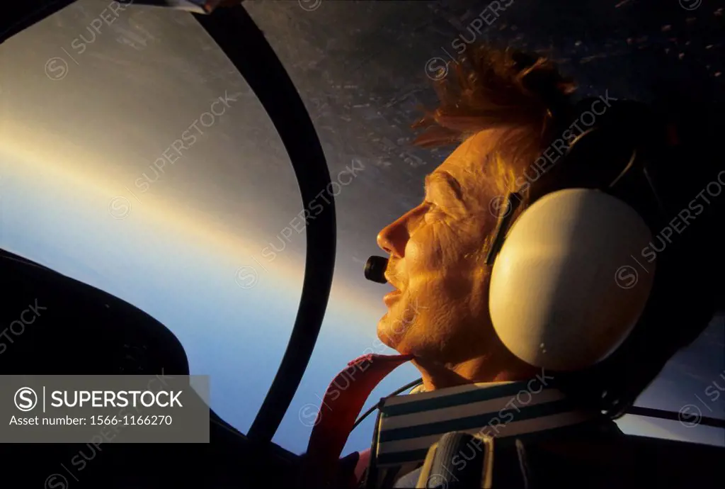 Inside view of a pilot portrait during a looping flight on sunset with a french Cap 10b plane, France
