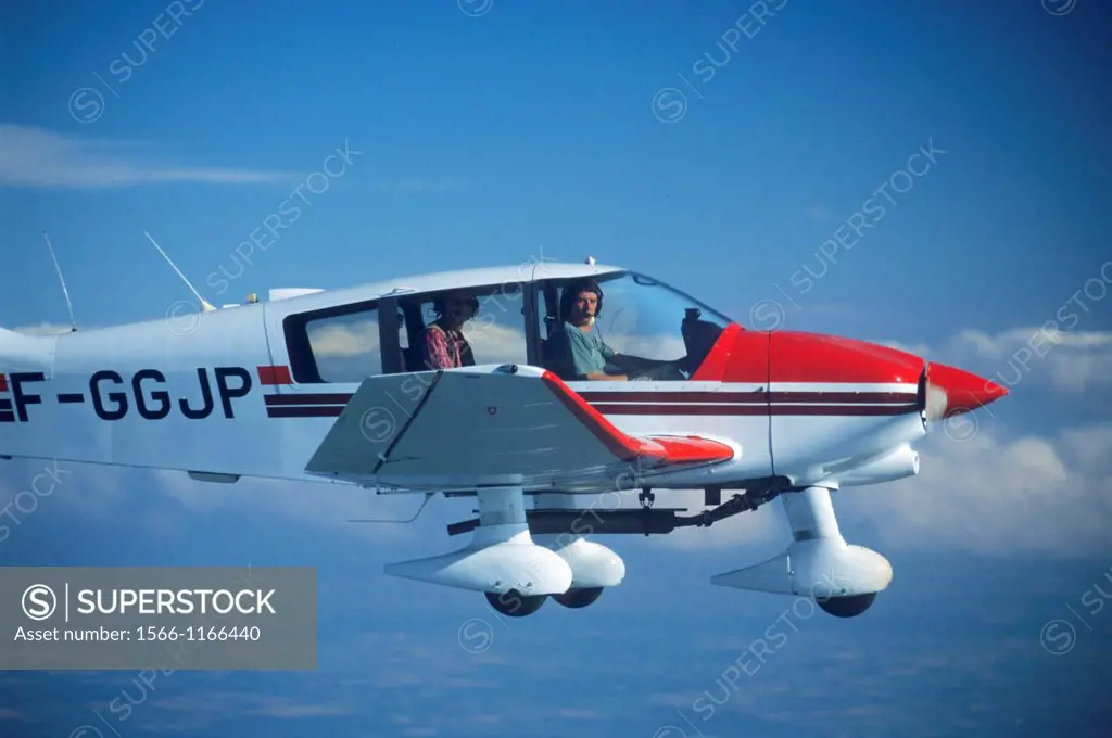 French plane Robin DR400-180 in flight over clouds, France
