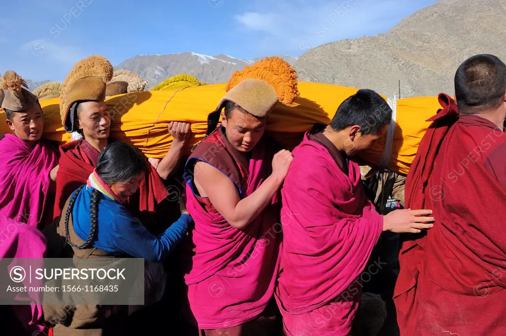 China, Gansu, Amdo, Xiahe, Monastery of Labrang Labuleng Si, Losar New Year festival, Tibetan devotee and giant Thangka bearers