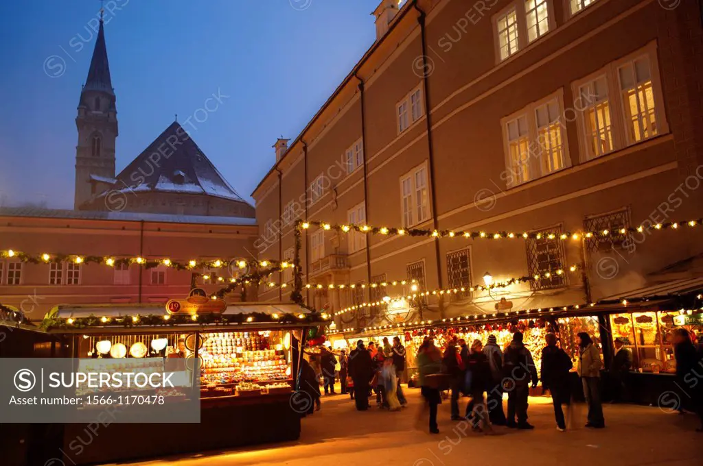Christmas market stalls at night with Christams lights at Satlzburgh market - Austria