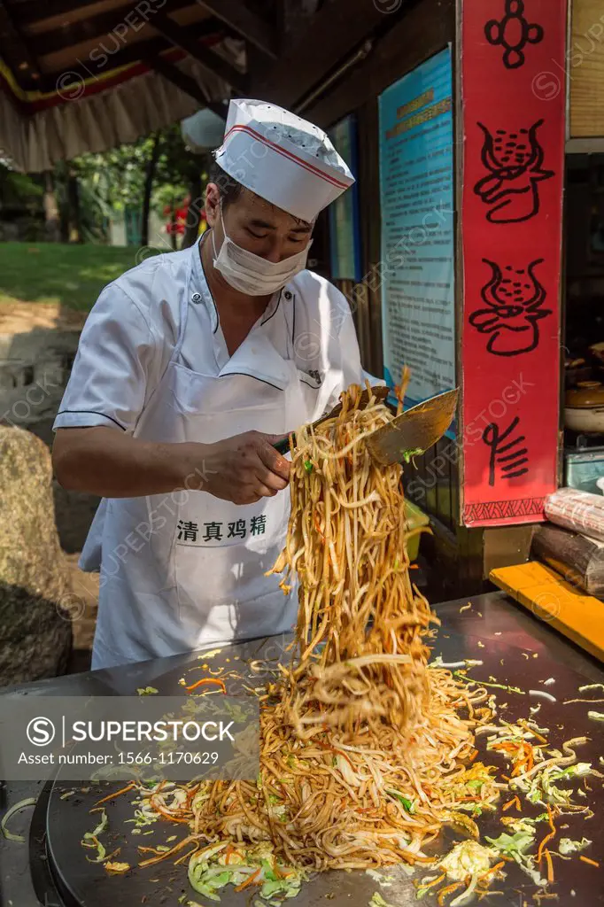 China , Shenzhen City, Splendid China Park, cook , frying noodles