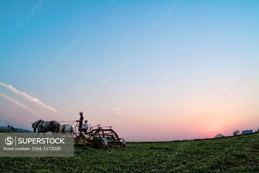 Old Amish Farm with man on plow working fields Intercourse Pennsylvania