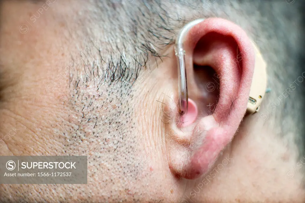 ear of elderly man with Hearing aid