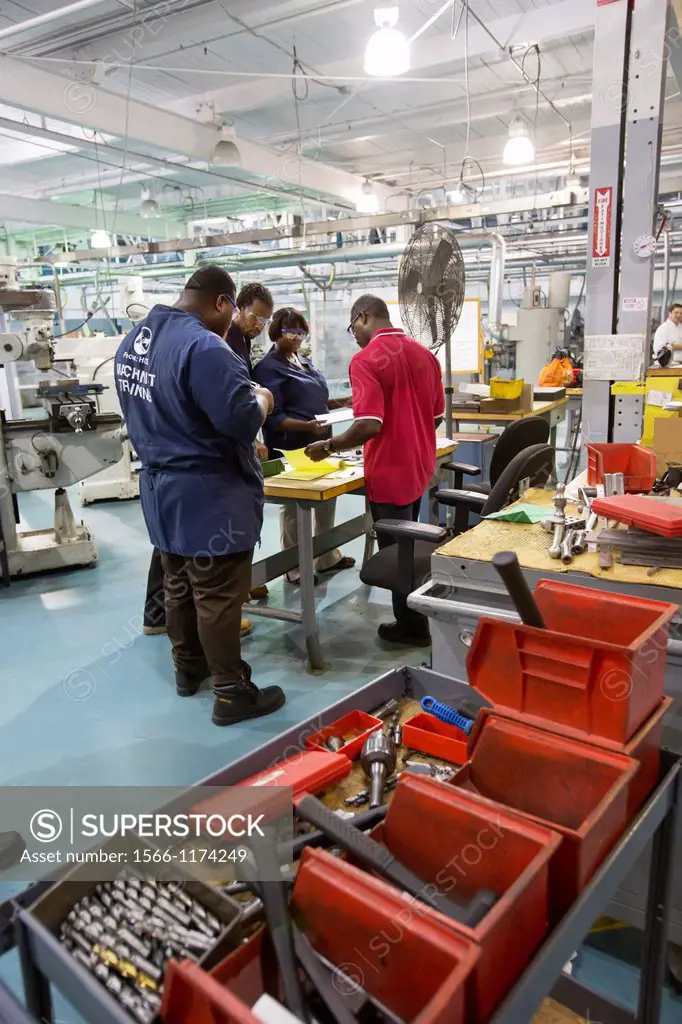 Detroit, Michigan - An instructor red shirt works with students at the Machinist Training Institute at the social service agency Focus: HOPE  MTI grad...