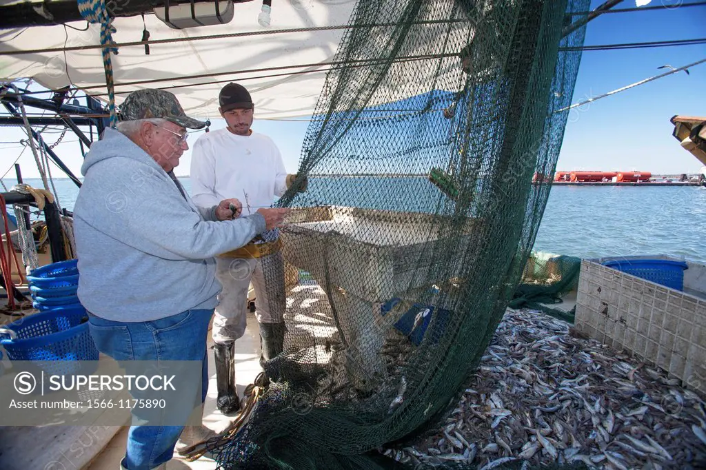 Mobile, Alabama - A shrimp trawler on Mobile Bay  Jackie Schwartz left and Darrell Goleman mend a net they had to cut open to remove a log  The trawle...