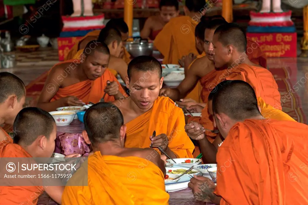 Buddhist Monks taking their lunch in the refectory of the Kampong Ampil monastery, Battambang, Cambodia