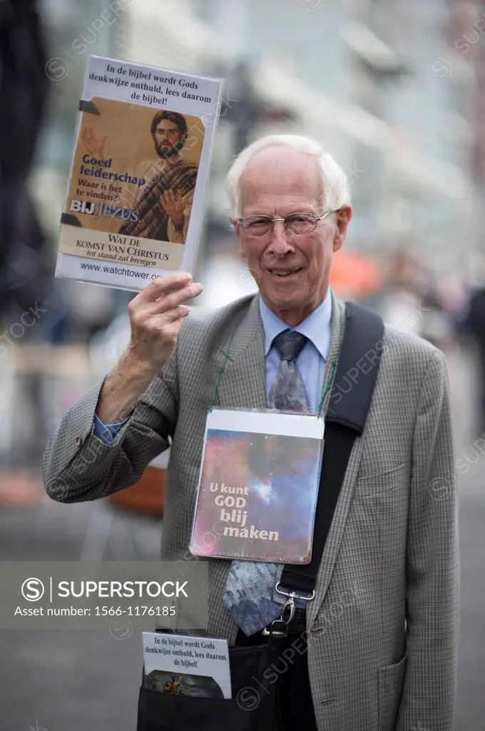 Rotterdam, Netherlands. Elder, Christian man and Jehovah´s Witnesses spreading God´s words in the streets.