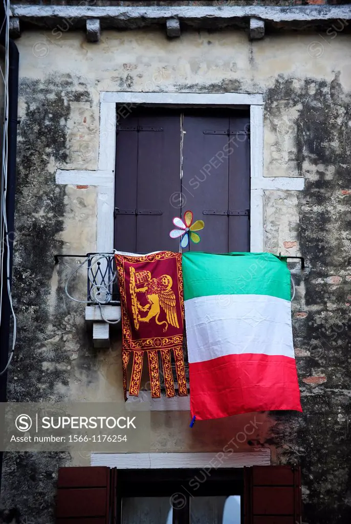 Italian and pro-Venetian independence flags at window in Venice,Italy,Europe