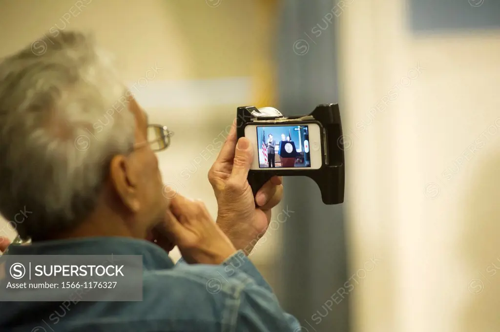A senior citizen reporter uses his iPhone to record video for his blog of a NYC Mayor Mike Bloomberg press conference at the Blue Room, City Hall in N...