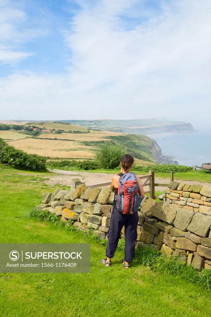 Female hiker on The Cleveland Way national trail coastal footpath near Hummersea, between Saltburn and Staithes, North Yorkshire, England, United King...