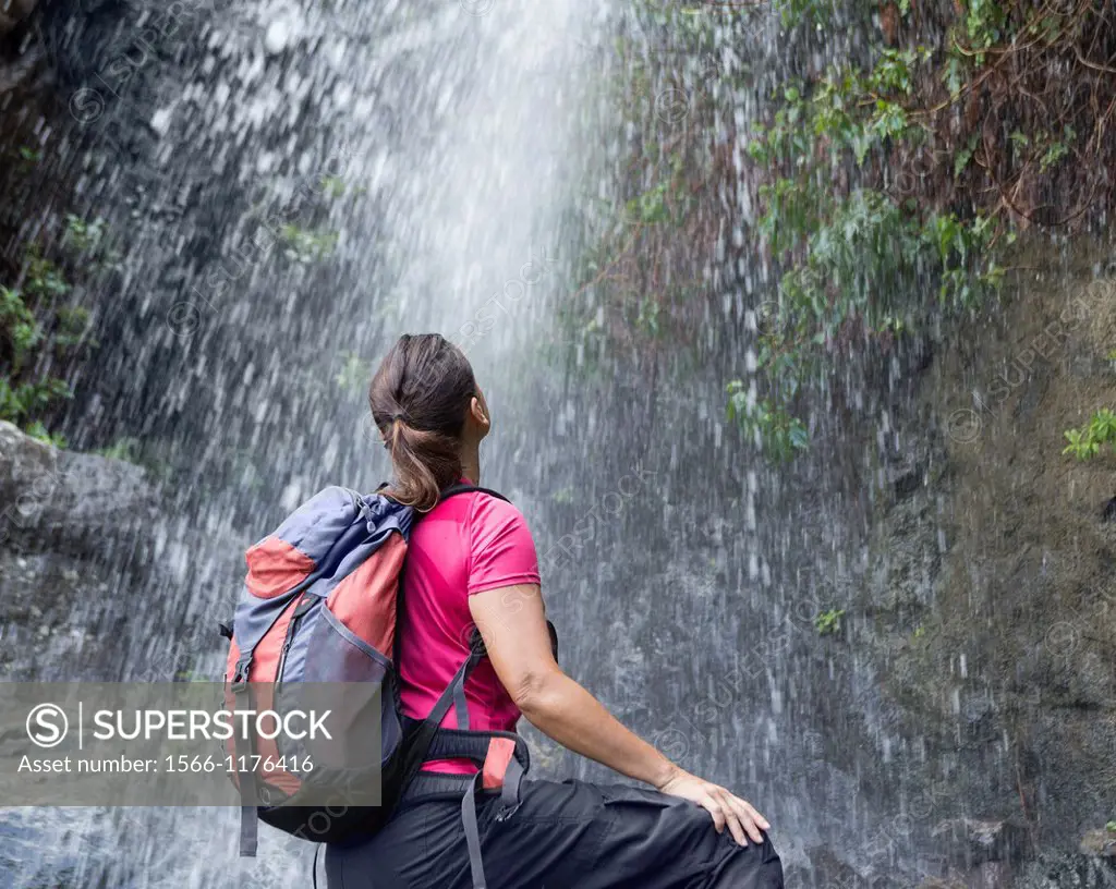 Female hiker at mountain waterfall on Gran Canaria, Canary Islands, Spain