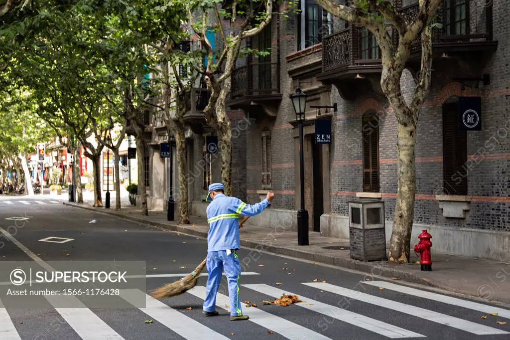 A street sweeper cleans up in Xintiandi Plaza shopping district Shanghai, China