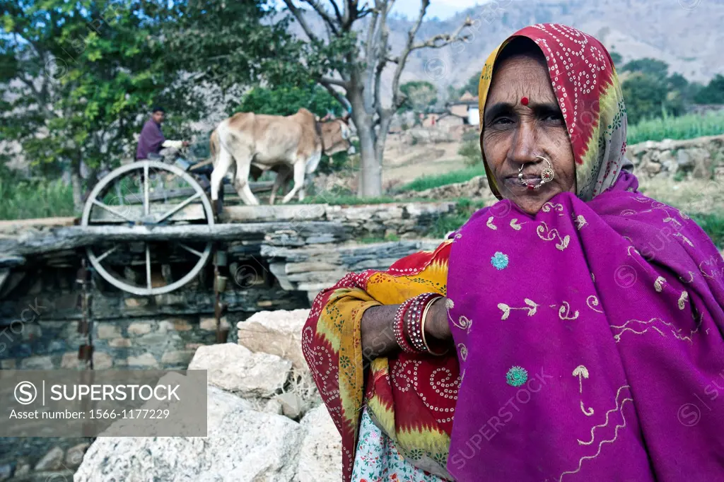 Indian woman in traditional clothes at water wheel well Rajasthan India